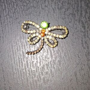Elegant Dragonfly Brooch with Green and Orange Accents..